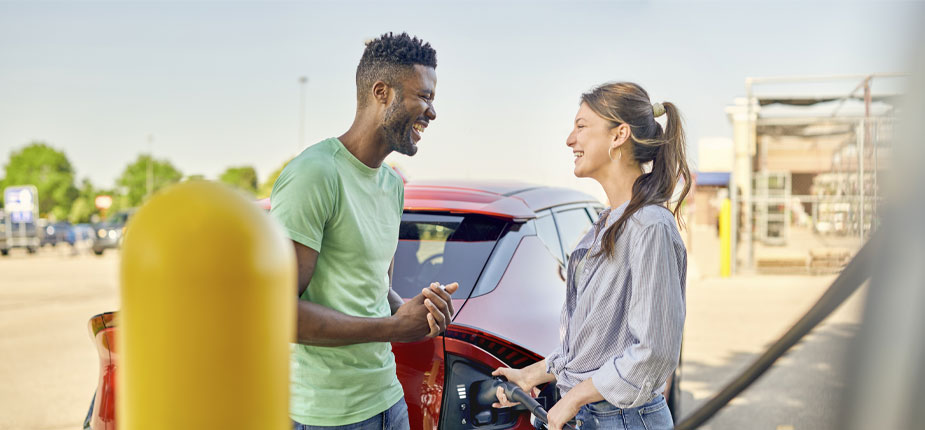 Couple chatting at EV charging station